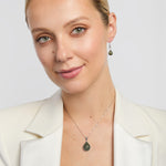 connemara marble teardrop-shaped earrings and matching teardrop pendant on a model