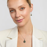 connemara marble teardrop-shaped earrings and matching teardrop pendant on a model