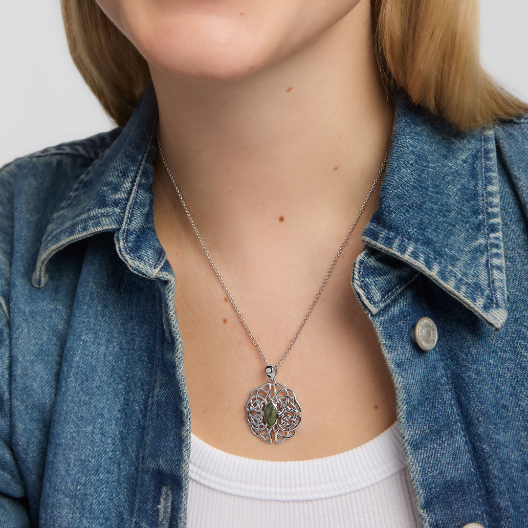 close-up image of oval connemara marble large celtic knot pendant on a female model  