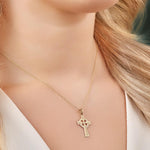 a model wearing hand engraved gold celtic cross necklace