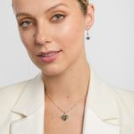 Model showcases heart-shaped Connemara marble necklace and matching earrings set