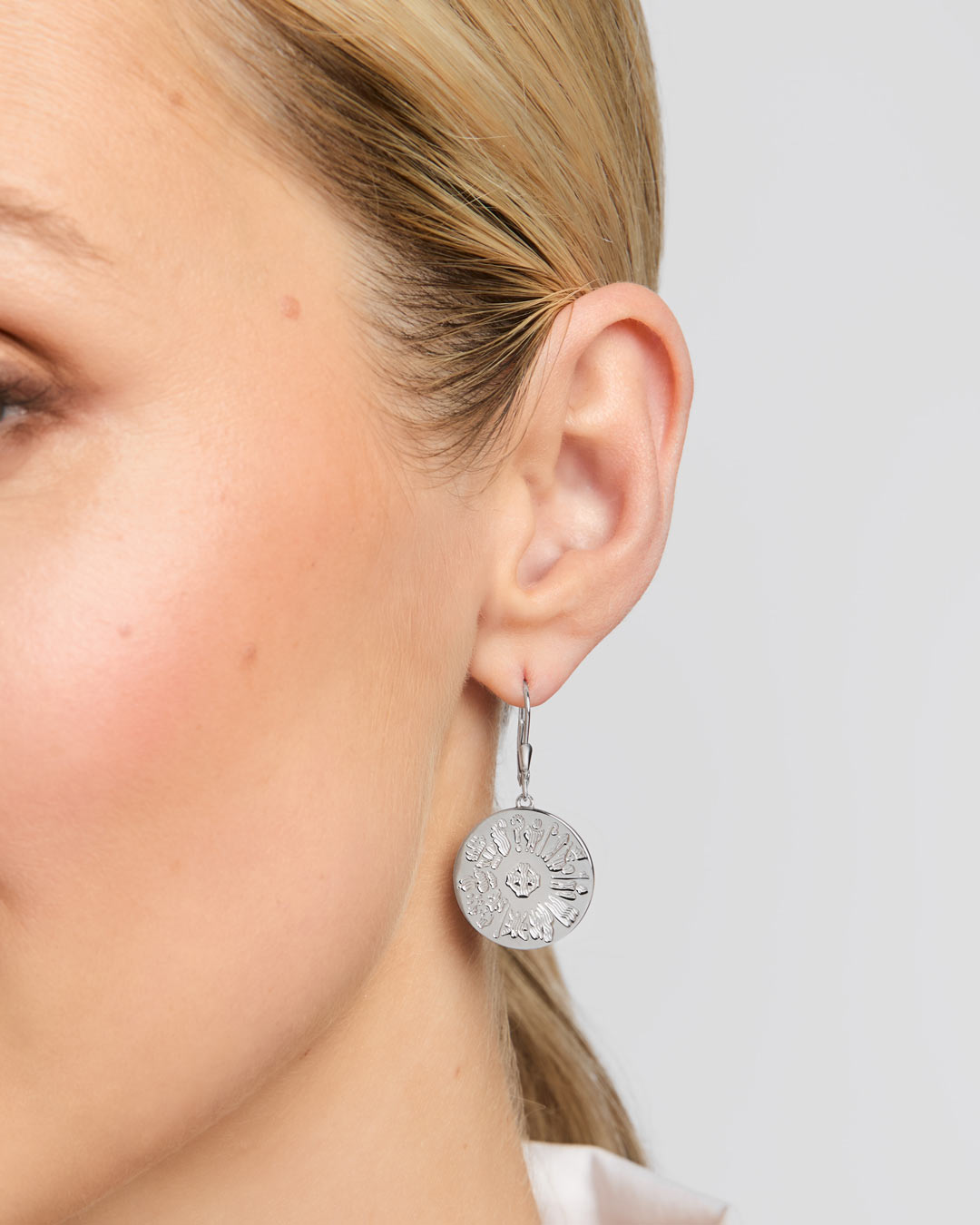 History of Ireland disc earrings on a model