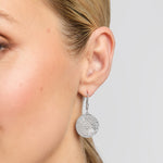 History of Ireland disc earrings on a model