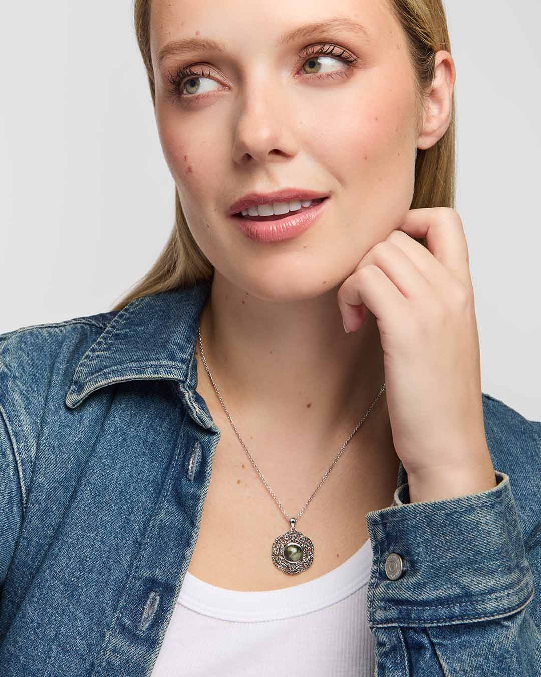 Female model wearing Solvar Connemara marble pendant surrounded by intricate marcasite-set Celtic knotwork on a silver chain