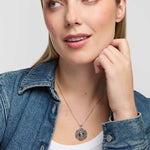 Female model wearing Solvar Connemara marble pendant surrounded by intricate marcasite-set Celtic knotwork on a silver chain