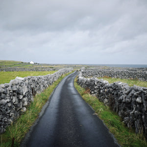 irish country road surrounded by stone walls