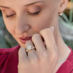 closeup image of diamond claddagh ring on model's hand