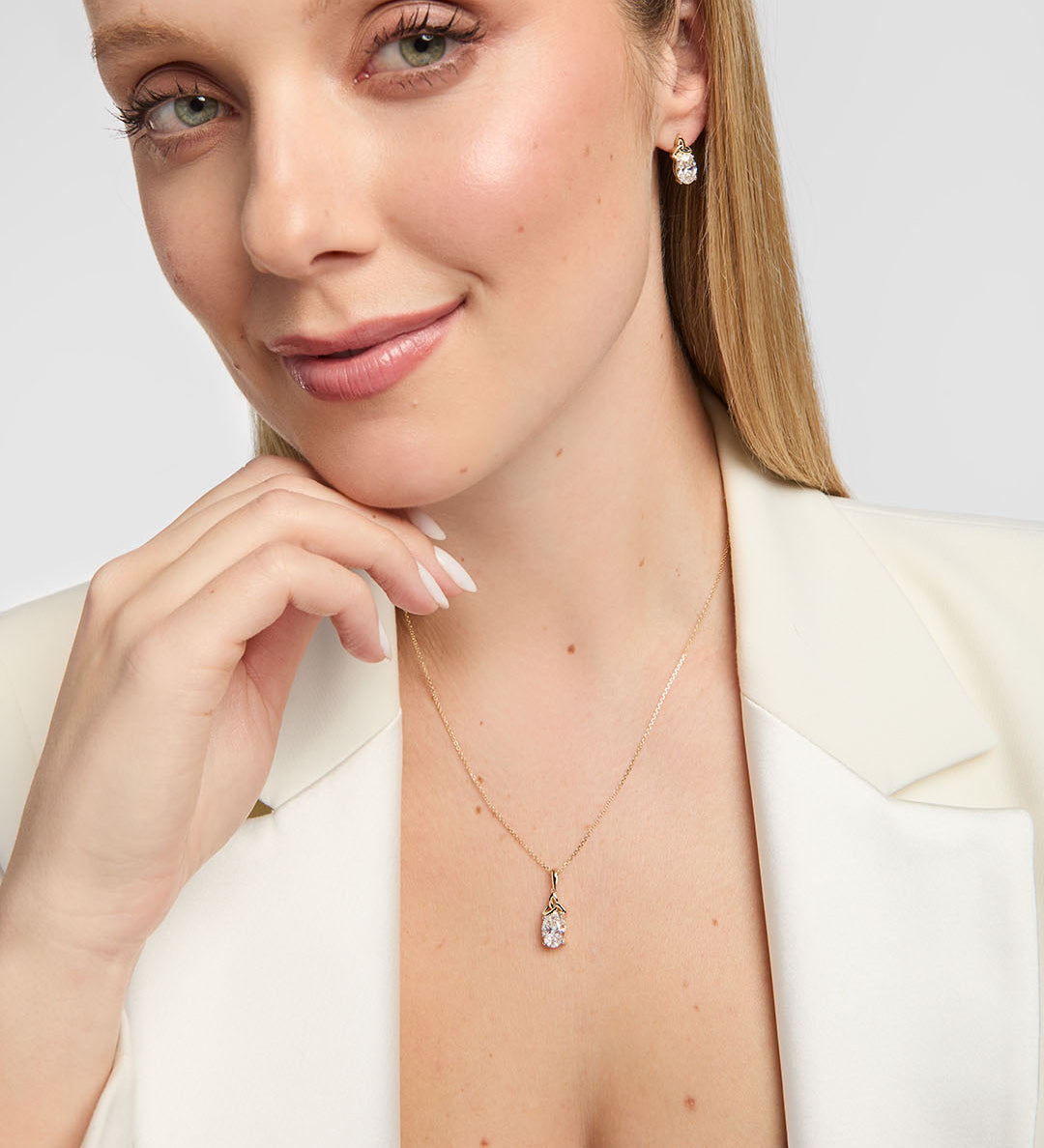 Model wearing matching lab-grown diamond Trinity Knot necklace and earrings