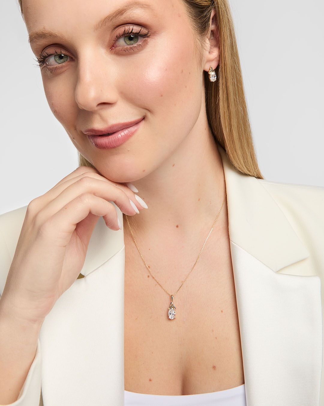 Model wearing matching lab-grown diamond Trinity Knot necklace and earrings
