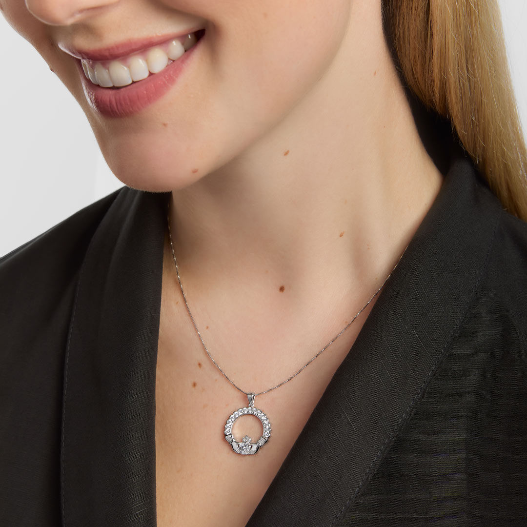 close-up image of cz claddagh necklace on a female model