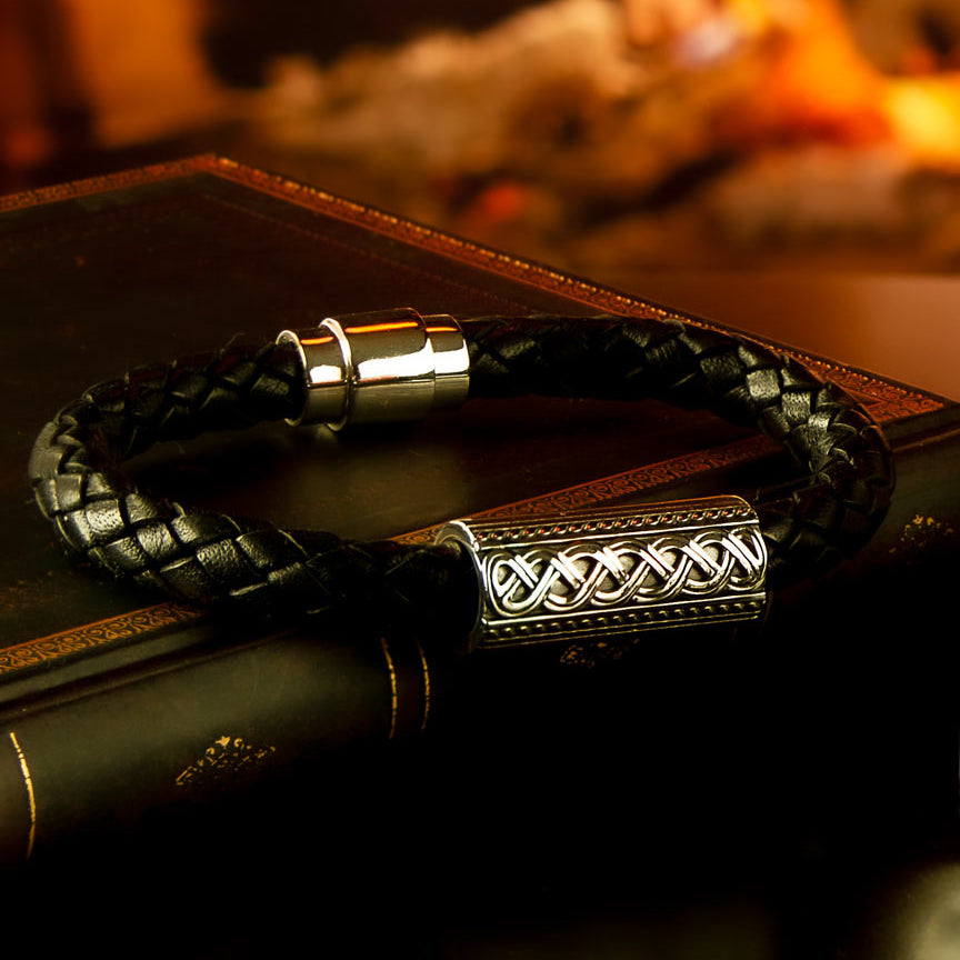 styled image of leather Celtic bracelet for men on open fire background