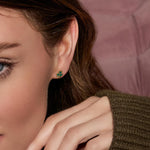 a model wearing yellow gold malachite shamrock earrings from Solvar