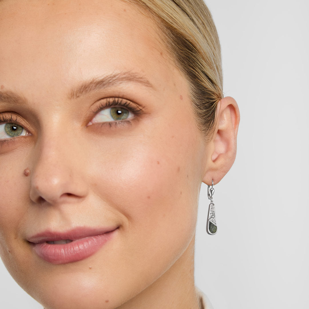 Connemara marble trinity knot set drop earrings on a model