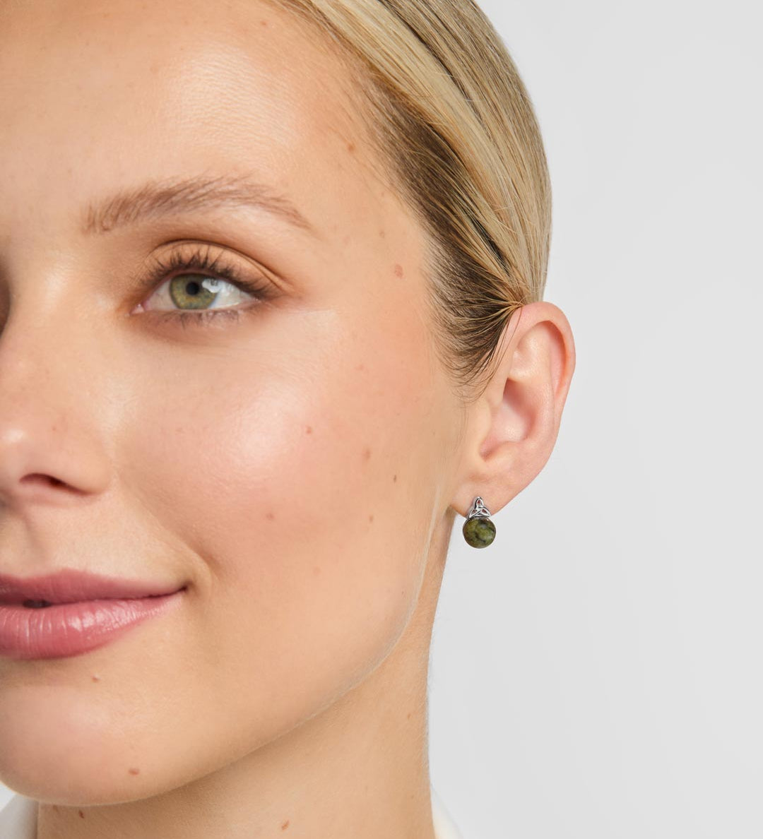 Connemara marble celtic stud earrings on a model