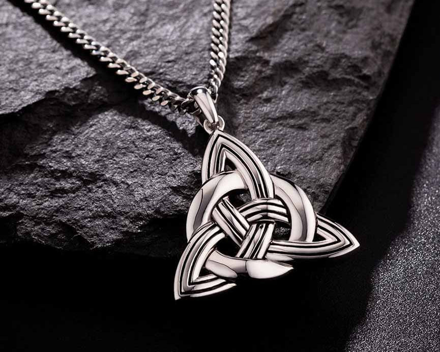 lifestyle image of mens heavy celtic knot pendant on dark background