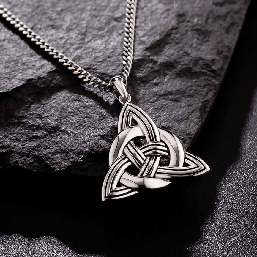 lifestyle image of mens heavy celtic knot pendant on dark background