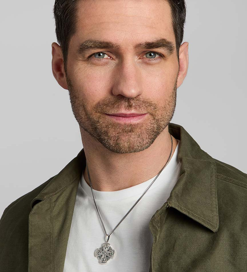 male model wearing oxidised silver Celtic cross necklace crafted by Solvar