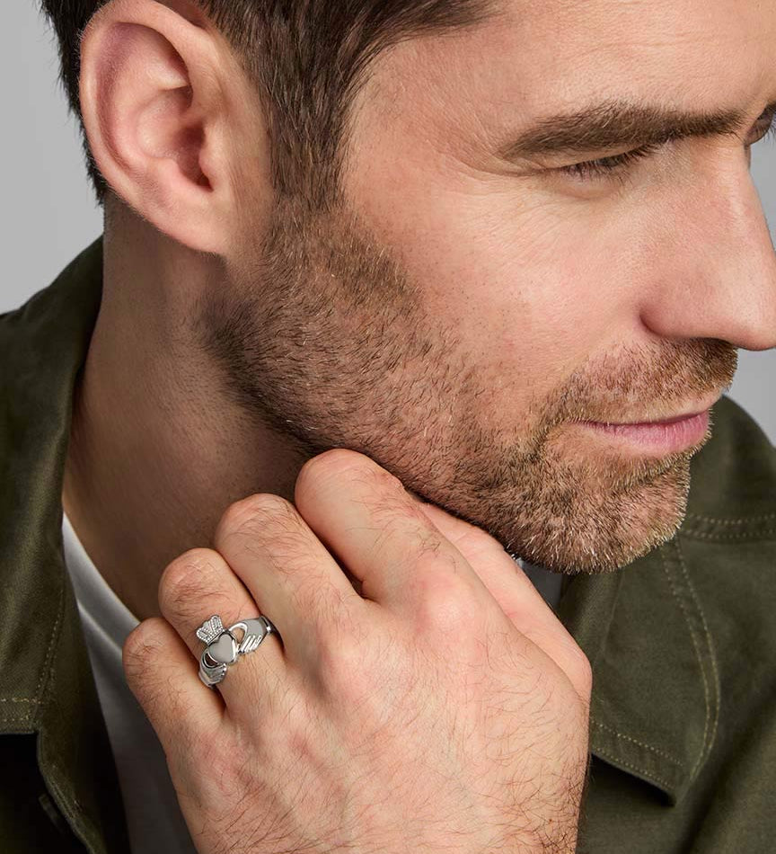 a male model wearing claddagh ring in silver
