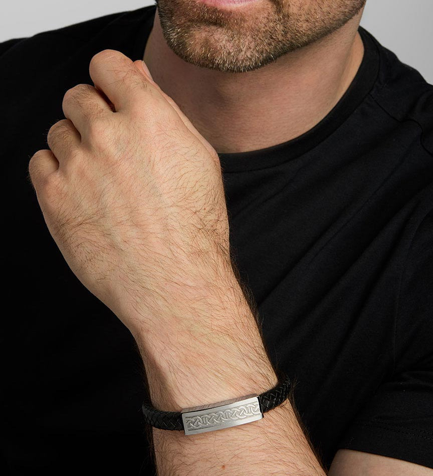 a male model wearing black leather wide Celtic bracelet from Solvar