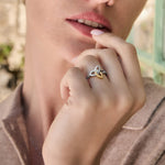 Close-up image mixed metal Celtic ring on a model outdoors.