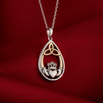 lifestyle image of Celtic Claddagh necklace on red background