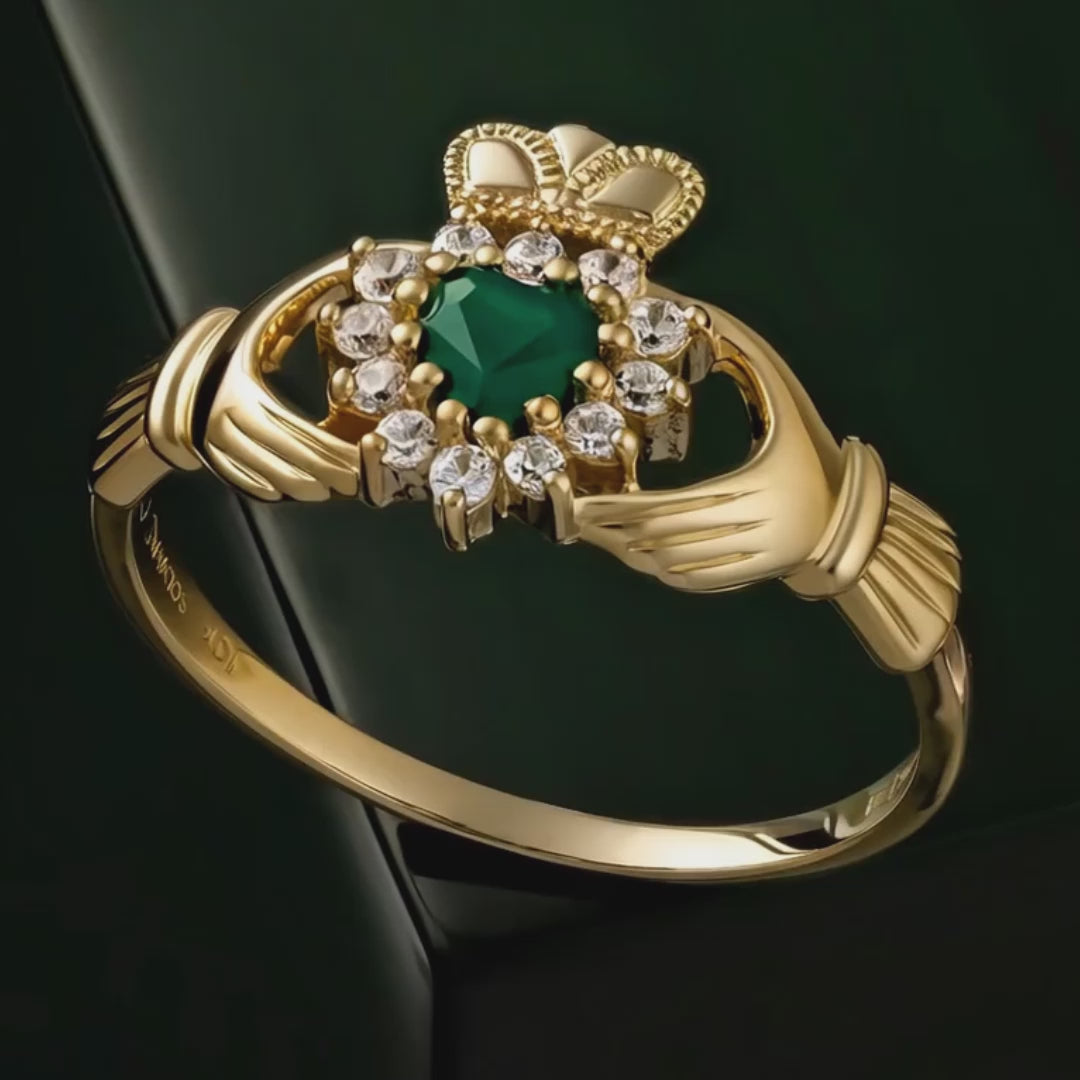 Gold Claddagh ring with Green Agate centre rotating on dark green background