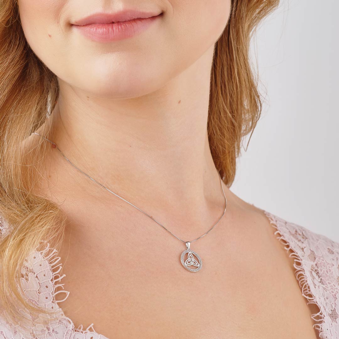 a model wearing Solvar sterling silver cz round trinity knot necklace s47013