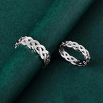 his and hers silver Celtic Knot rings in silver on green background