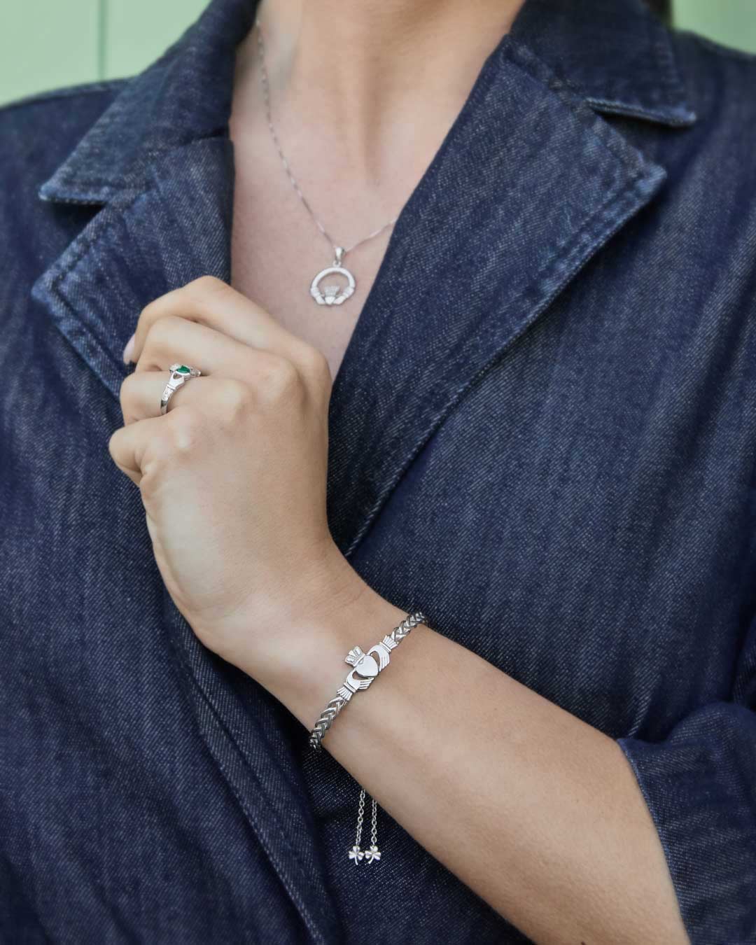 model wearing silver claddagh jewellery set of bracelet, necklace and ring