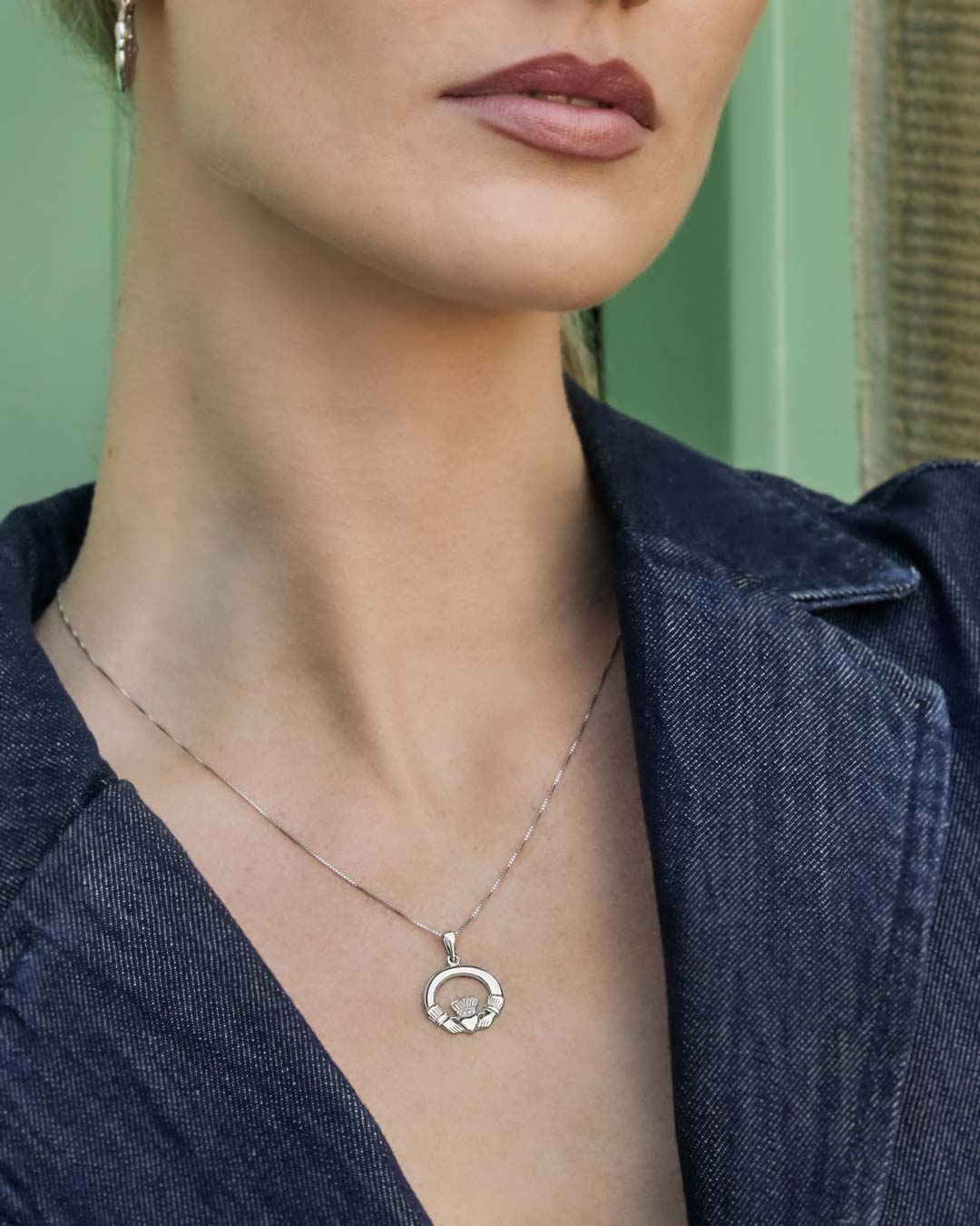 model wearing silver Claddagh necklace
