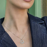 model wearing silver Claddagh necklace