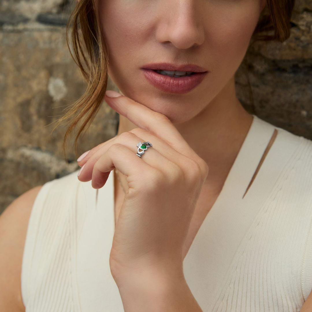 styled image of sterling silver claddagh emerald ring s2594 on a model 1