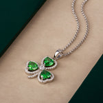 lifestyle image of silver green cubic zirconia shamrock pendant from Solvar