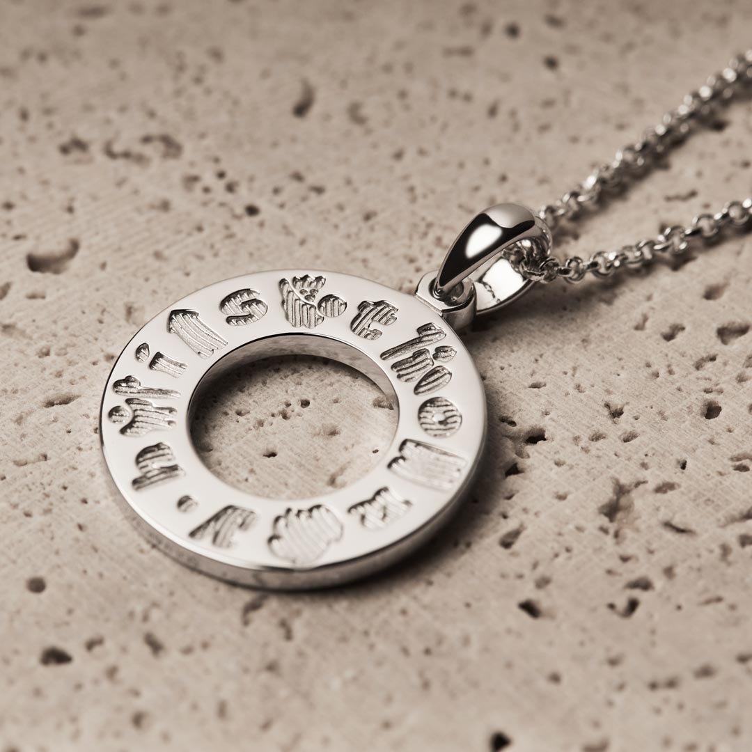 lifestyle image of History of Ireland Doughnut shaped necklace in silver