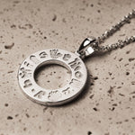 lifestyle image of History of Ireland Doughnut shaped necklace in silver