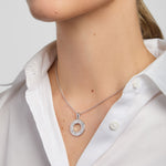 model wearing silver History of Ireland doughnut shape pendant necklace