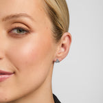 small silver trinity knot stud earrings on a model