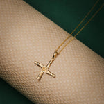lifestyle image of gold Saint Brigids cross necklace from Solvar