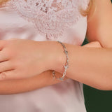 silver celtic style bracelet on a model's hand