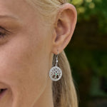 Irish tree of life drop earrings in silver on model