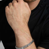 closeup image of men's heavy Celtic Trinity Knot bracelet in silver on a model