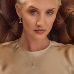 model wearing yellow gold trinity knot necklace and earrings set from Solvar