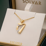two tone gold harp pendant s44063 in a branded solvar jewellery box