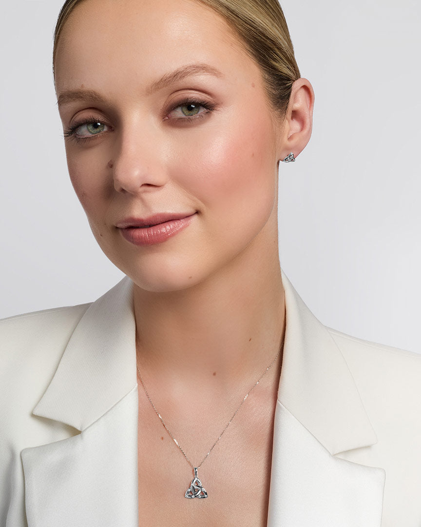 a model wearing a set of white gold diamond trinity knot jewellery 